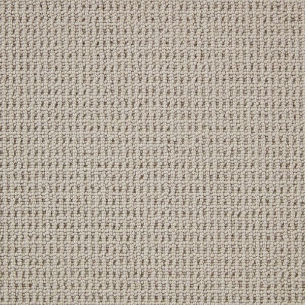 Close-up image of a beige, textured carpet with a looped weave pattern.