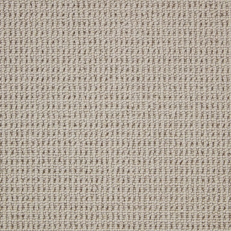 Close-up image of a beige, textured carpet with a looped weave pattern.