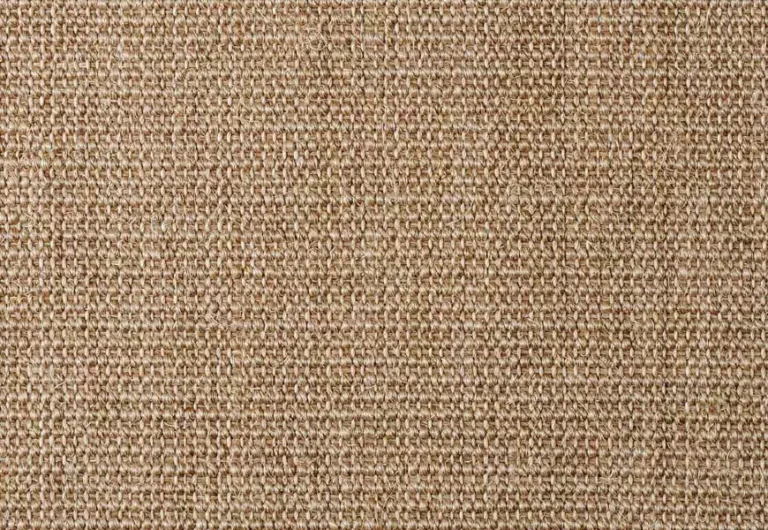 Close-up image of a woven fabric in a beige, light brown color, showing a textured and tightly knit pattern.