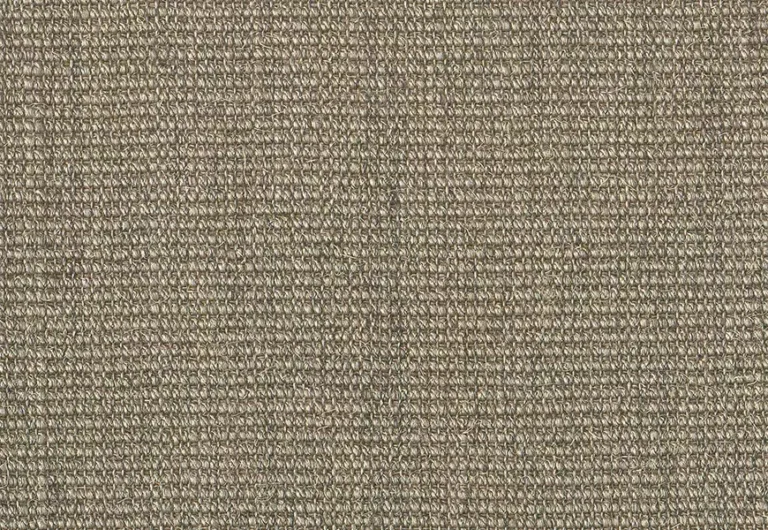 A close-up of a textured, beige fabric with a tightly woven pattern.