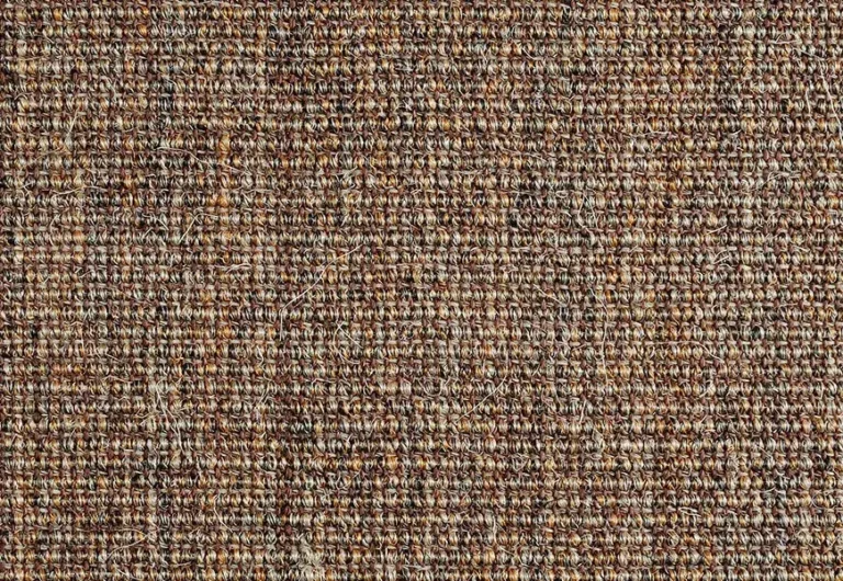A close-up of a textured brown woven fabric, showing an intricate pattern of interlaced fibers.