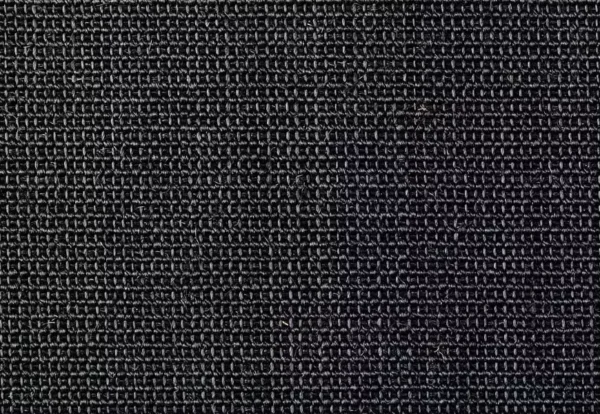 Close-up of a dark, textured fabric with a tightly woven pattern. The fabric appears durable and dense.