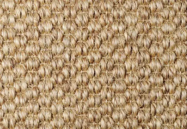 Close-up of a woven beige textured fabric or matting, featuring a repetitive pattern of tightly interwoven fibers.