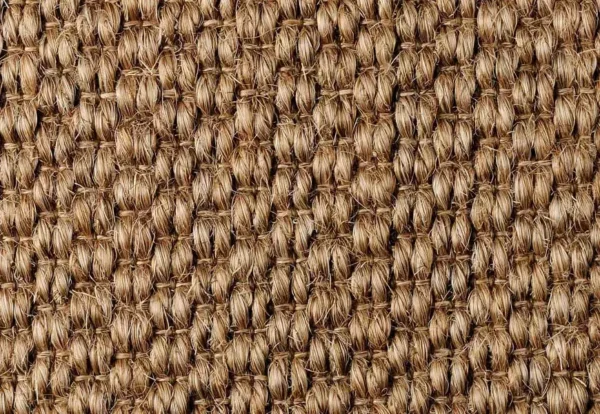 Close-up of a woven natural fiber fabric with a tightly-knit pattern in shades of brown.