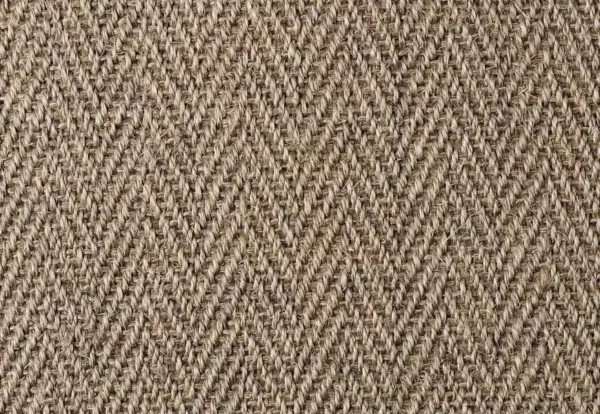 A close-up view of a beige herringbone fabric texture with a zigzag pattern.