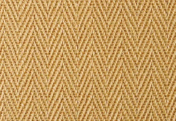 Close-up view of a woven fabric with a herringbone pattern in a light beige color.