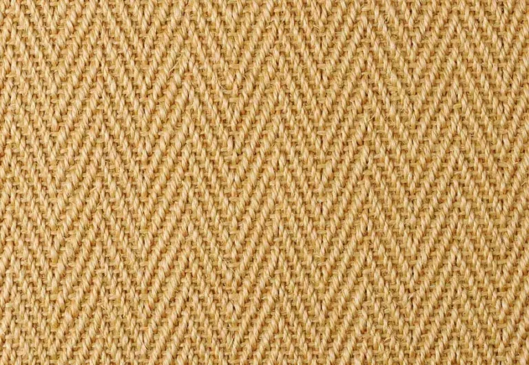 Close-up view of a woven fabric with a herringbone pattern in a light beige color.