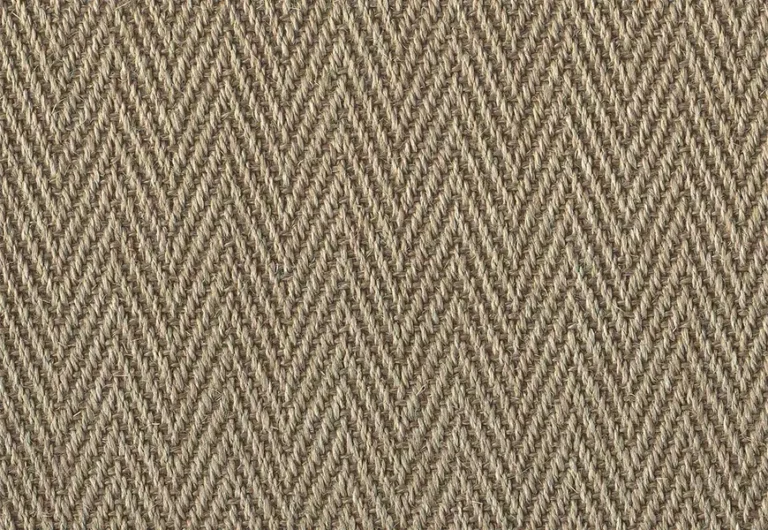 A close-up view of a beige herringbone patterned woven fabric, showing a repeating zigzag design.