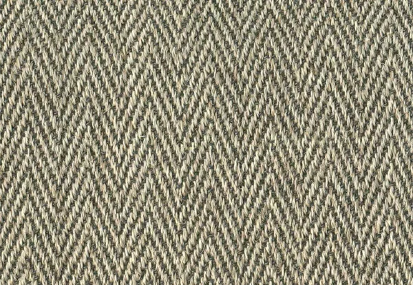 Close-up of a fabric with a herringbone pattern in shades of brown and beige.