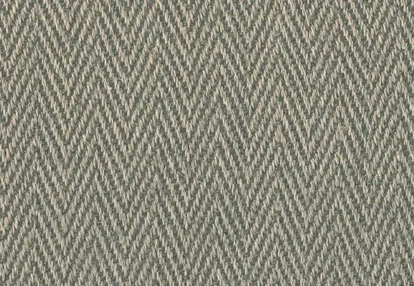 Close-up of a woven fabric with a herringbone pattern in shades of beige and gray. The texture shows tightly interlaced fibers forming a diagonal zigzag design.