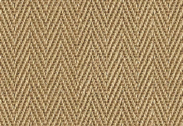 A close-up of a woven herringbone pattern in beige fibers. The texture appears coarse and the pattern consists of alternating diagonal lines.