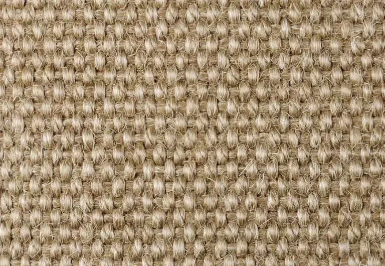 Close-up view of a woven beige fabric with a textured, grid-like pattern made of tightly interlaced fibers.