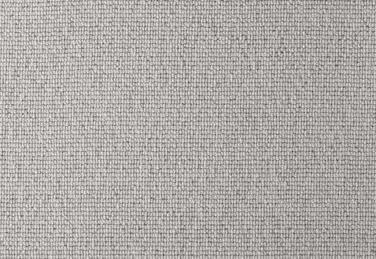 Close-up of a light grey textured woven fabric with a grid-like pattern.