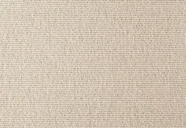 A close-up of a beige, tightly woven fabric with a uniform texture.