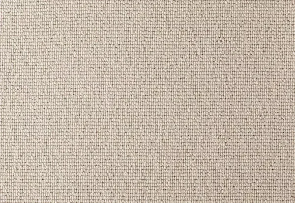 A close-up of a beige woven fabric with a grid-like pattern. The texture appears coarse and the design is uniform.