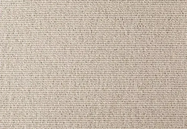 Close-up of a beige textured woven fabric with a grid-like pattern. The material appears to be tightly woven, creating a uniform and consistent surface.