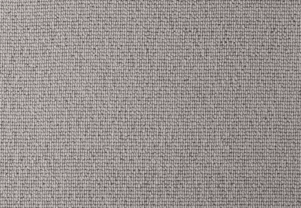 A close-up view of a textured, light grey, woven fabric with a uniform pattern.