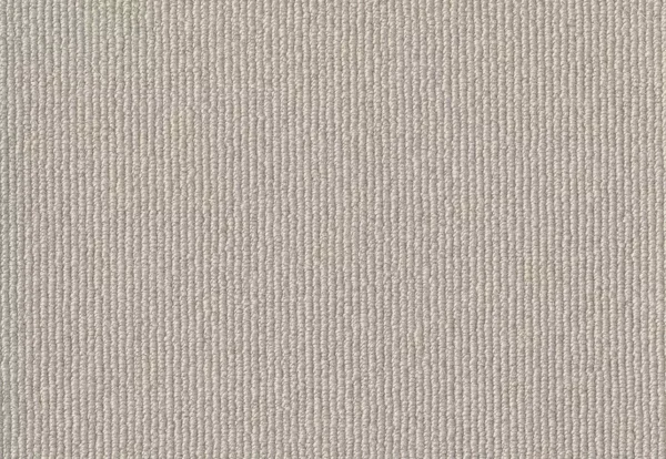 Close-up view of a beige carpet with a tightly woven, textured pattern.