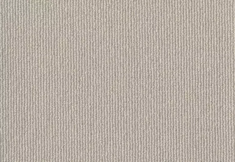 Close-up view of a beige carpet with a tightly woven, textured pattern.