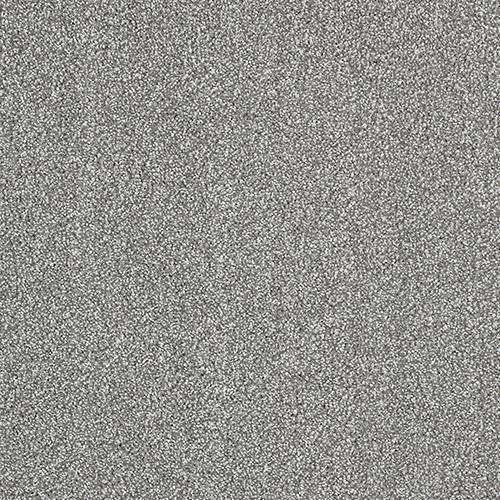 Close-up view of a coarse, grey, textured surface resembling sandpaper or rough concrete.