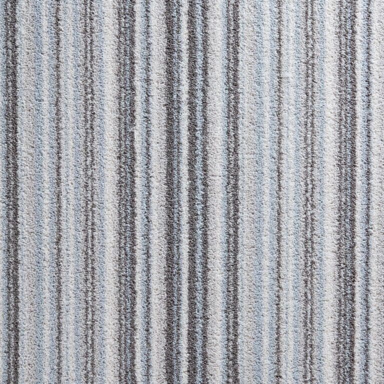 Close-up of a Durham Stripes carpet with vertical lines in shades of gray and light blue. The texture appears soft and slightly coarse.