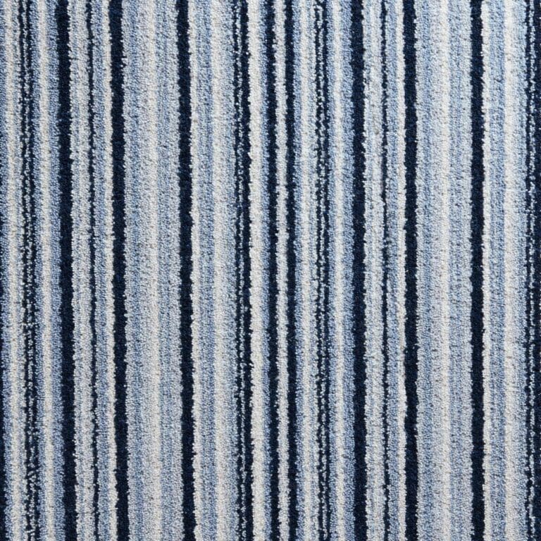 A close-up view of a textile surface featuring vertical stripes in varying shades of blue and white.