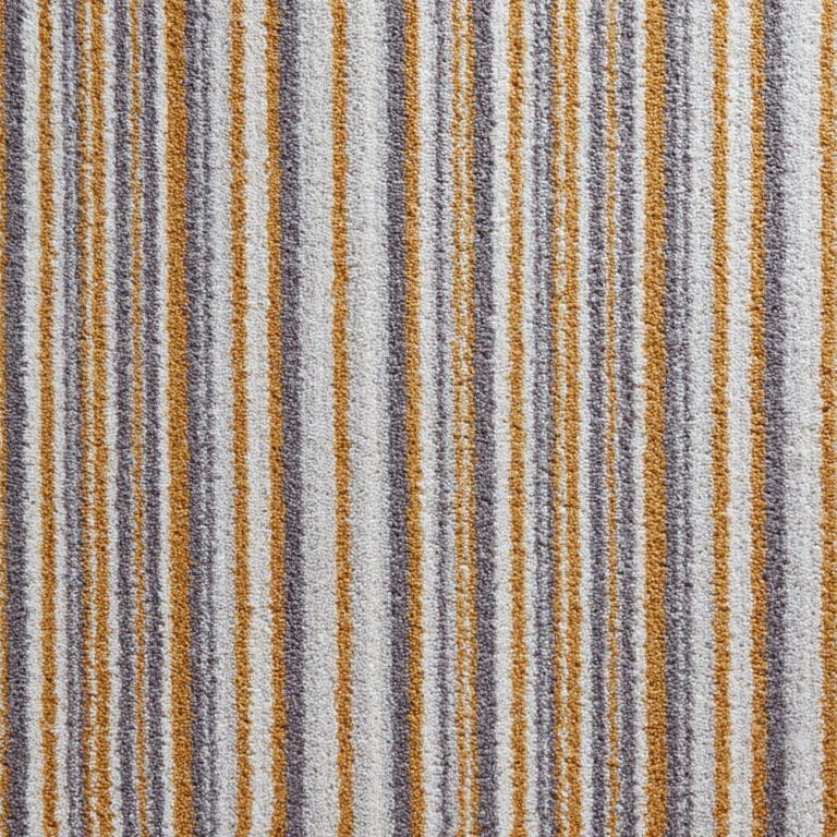 A close-up of a carpet with vertical stripes in white, gray, and mustard-yellow colors.