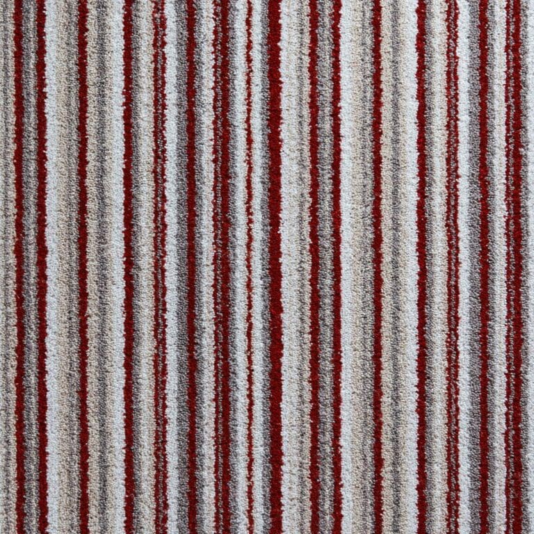 A close-up of a carpet with vertical stripes in various shades of red, white, and beige.