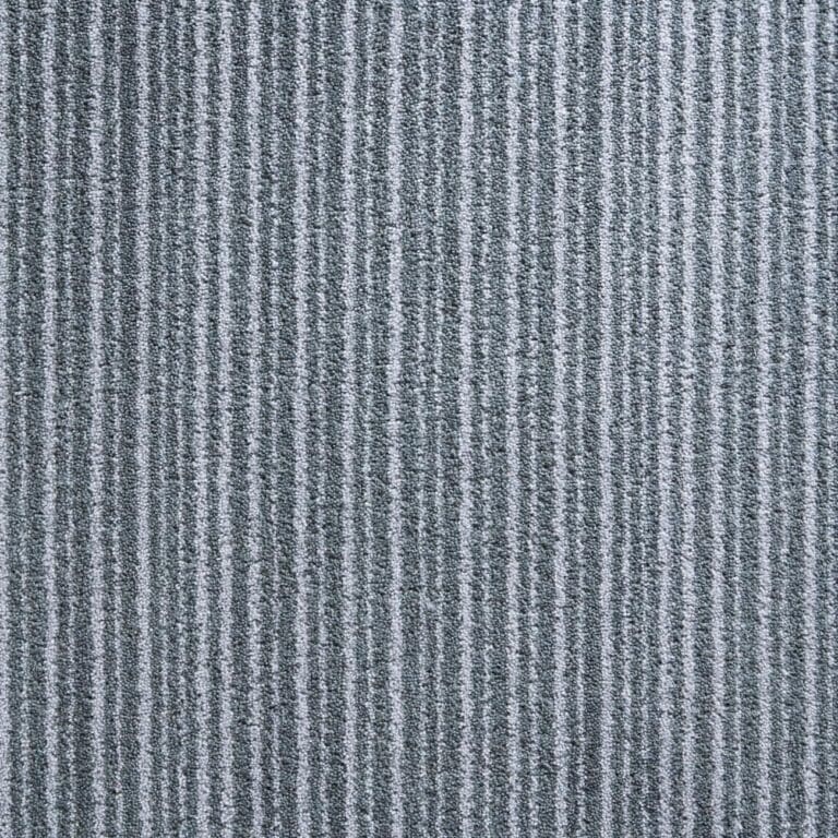 A close-up of a gray carpet with vertical textured stripes.
