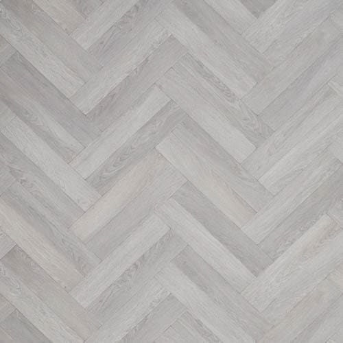 A close-up of a light grey herringbone-patterned wooden floor.