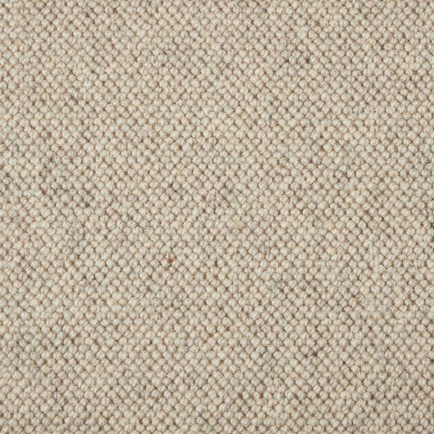 Close-up of a textured, beige-colored fabric with a tightly woven pattern.
