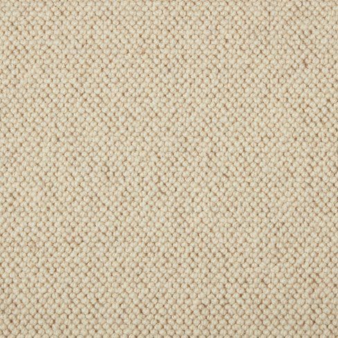 Close-up view of a textured beige fabric with a tightly woven pattern.