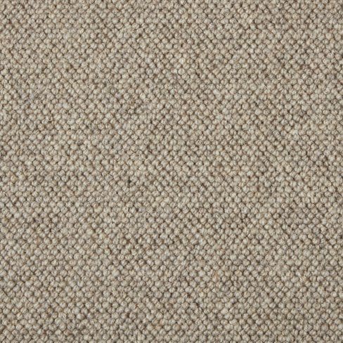 Close-up of a beige carpet with a tightly-woven, slightly textured surface.