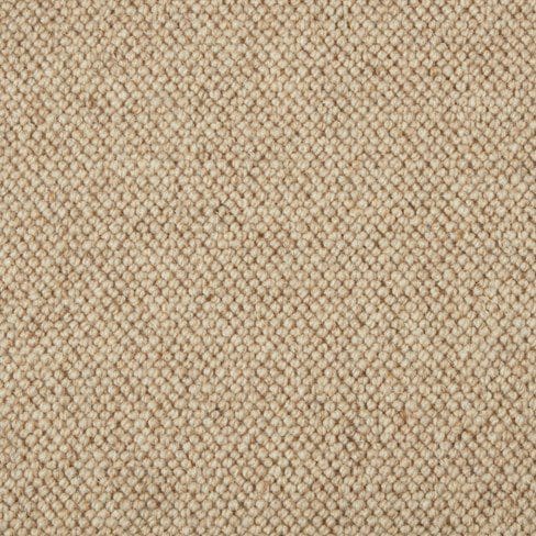 Close-up of a beige woven carpet with a tightly stitched, textured pattern.
