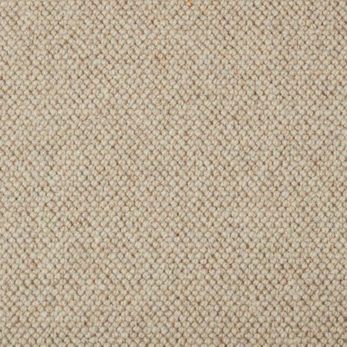 Close-up of a beige, textured woven fabric. The pattern consists of small, tightly interwoven loops creating a uniformly textured surface.