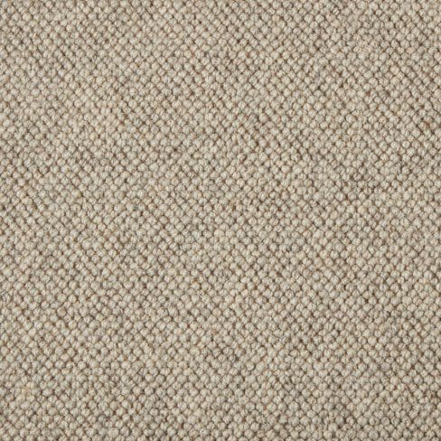 Close-up of a beige textured fabric with a tightly woven pattern.