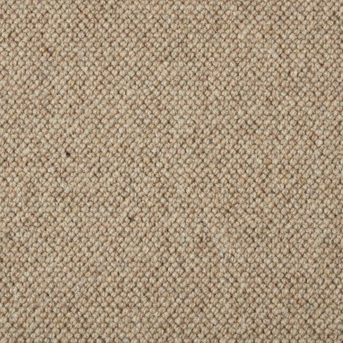 Close-up view of a beige, textured carpet with a looped pile design.