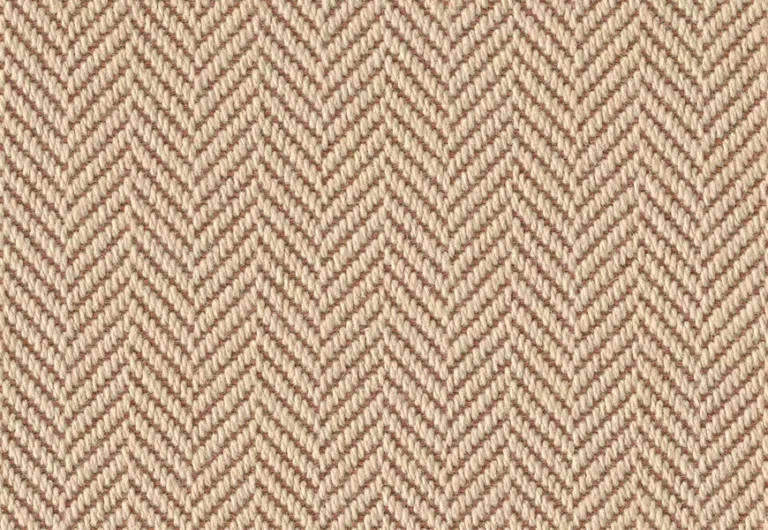 Close-up of a beige herringbone weave fabric, displaying a zigzag pattern with alternating diagonal lines.