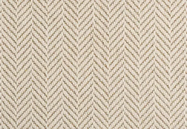 Close-up of a herringbone-patterned beige fabric with interlocking V shapes created by alternating weaves.