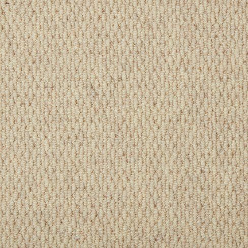 Close-up of a beige, textured woven fabric with a repeating diagonal pattern.
