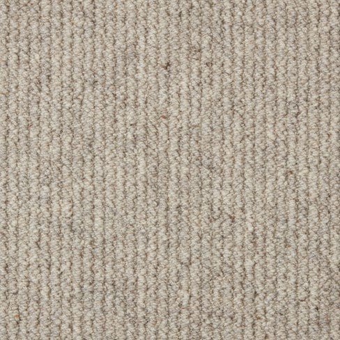 Close-up of a textured beige carpet with a vertical ribbed pattern.