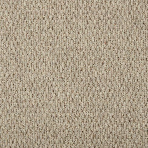 Close-up of a beige, loop-pile carpet with a textured, uniform pattern. The carpet fibers are tightly woven, creating a consistent and durable surface.