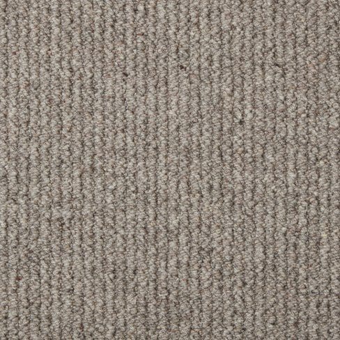 Close-up of a beige, textured, loop-pile carpet with a uniform pattern.