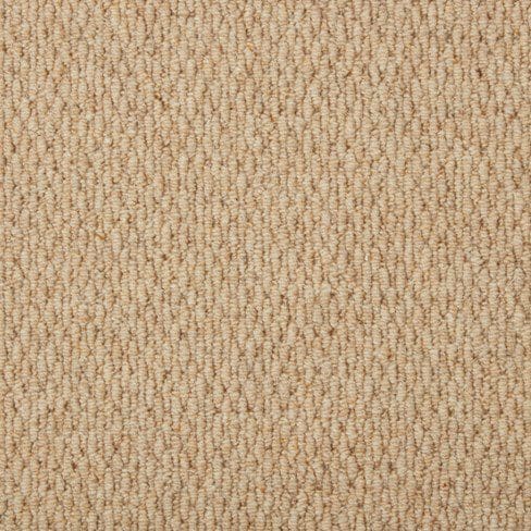 Close-up of beige textured carpet with a tight loop weave pattern.
