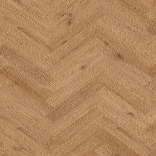 A close-up view of a herringbone parquet floor with a natural wood finish, showing the distinct pattern and wood grain texture.