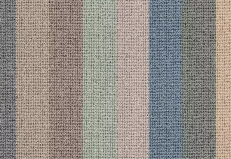 Close-up of a textured fabric featuring vertical stripes in muted pastel colors including beige, taupe, green, pink, and blue.
