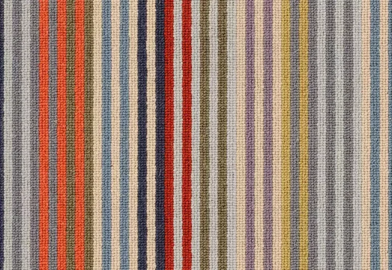 A textured fabric with vertical stripes in various colors, including red, blue, gray, orange, green, and yellow.