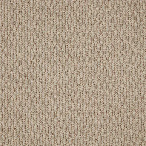 A close-up of light beige, textured, loop-pile carpet with a uniform pattern.