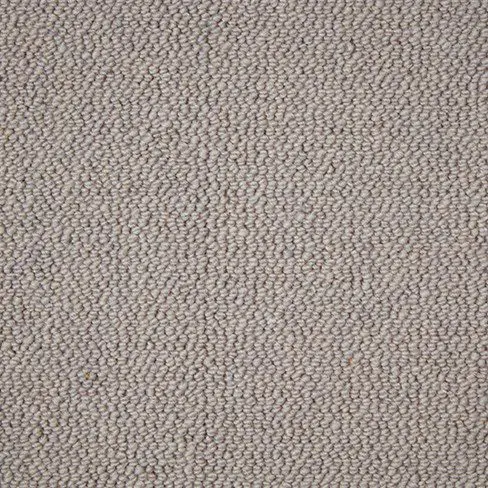 Close-up of a beige textured carpet with tightly woven fibers.