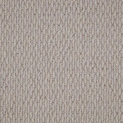 Close-up of a light beige, textured carpet with a looped pile weave pattern.